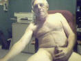 Senior retiree man nude in office
